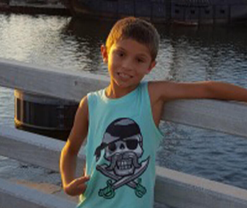 A young boy wearing a pirate tank top.