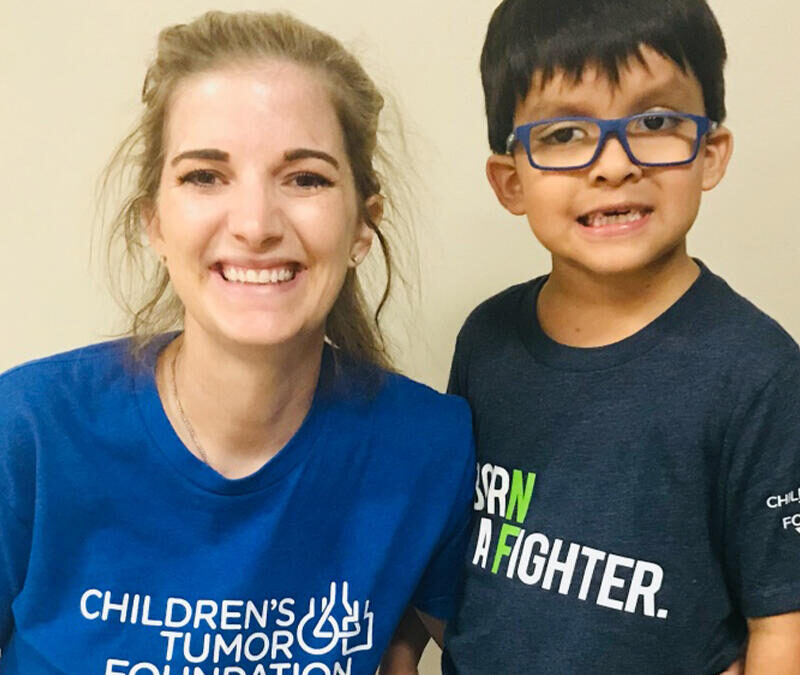 A woman and a boy posing for a photo in a t - shirt.
