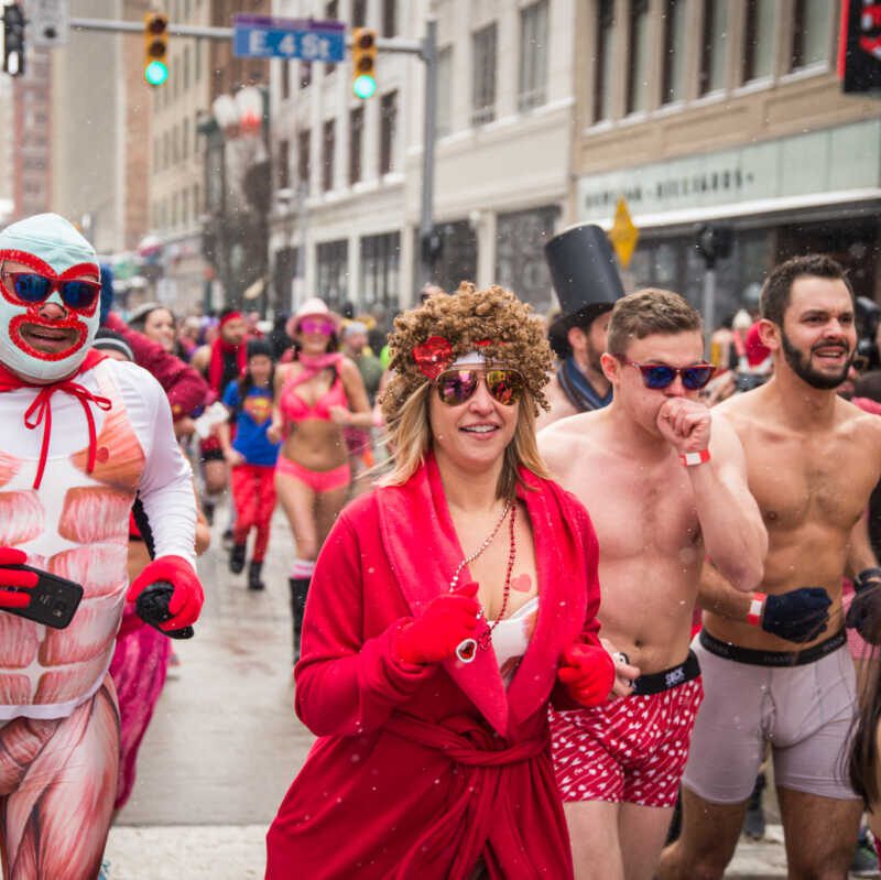 men and women running in their underwear and robes