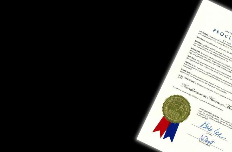 A certificate with a blue ribbon on it.