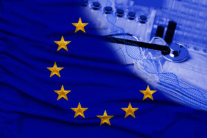 EU flag with medical stethoscope, syringes, and vials on a fabric background suggesting healthcare or medical research in Europe.