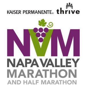 Logo for the Napa Valley Marathon and Half Marathon, sponsored by Kaiser Permanente Thrive, featuring a grape cluster integrated into the "V" in "NVM".