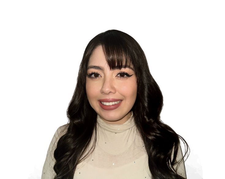 A woman with long dark hair and bangs smiles at the camera, wearing a light-colored top against a plain white background.