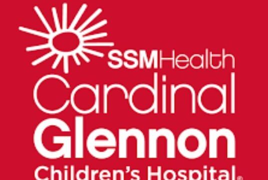 Logo of SSM Health Cardinal Glennon Children's Hospital with a stylized sun and text on a red background.