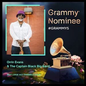 A bearded man wearing a purple hat and sunglasses stands holding a cane. The text highlights a Grammy nomination for Orrin Evans & The Captain Black Big Band.