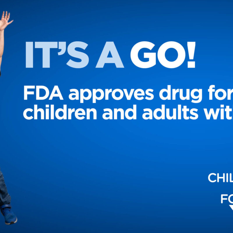 Child joyfully jumping, raising arms, wearing a "Halter" shirt on a blue background. Text: "IT'S A GO! FDA approves drug for children and adults with NF," with Children's Tumor Foundation logo.