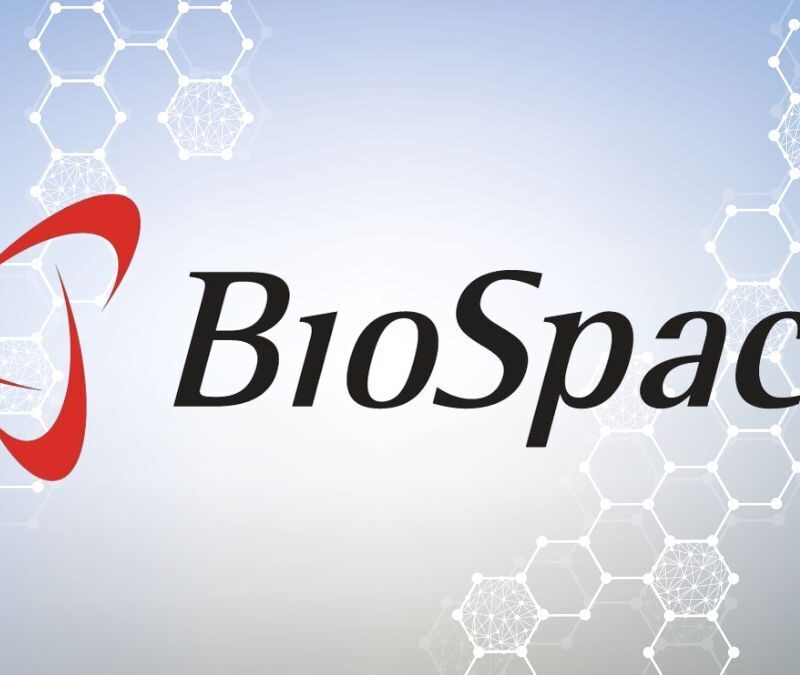 BioSpace logo featuring a red triangular symbol and black text, set against a light background with abstract hexagonal patterns.